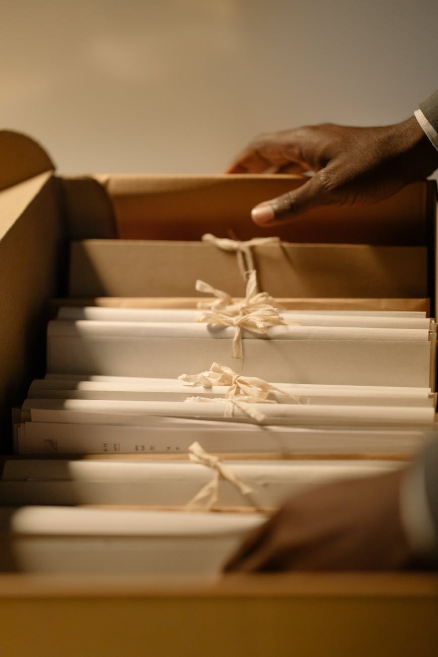 close up shot of a person holding a box of files